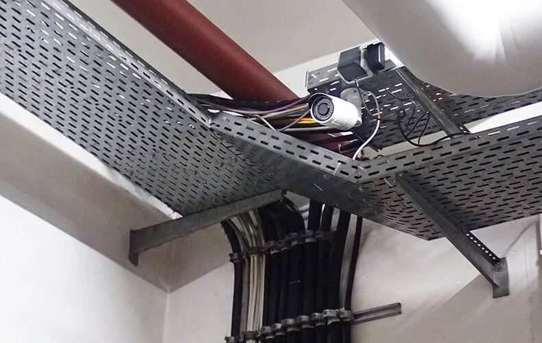 A surveillance camera on a metal scaffold