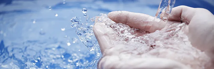 Hands scooping clean water